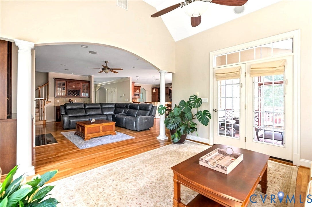 2220 French Hill Terrace, Powhatan, VA 23139 Views of Family Room from Sunroom. Notice Wet Bar, Hardwood Floors, Arched Opening and Columns