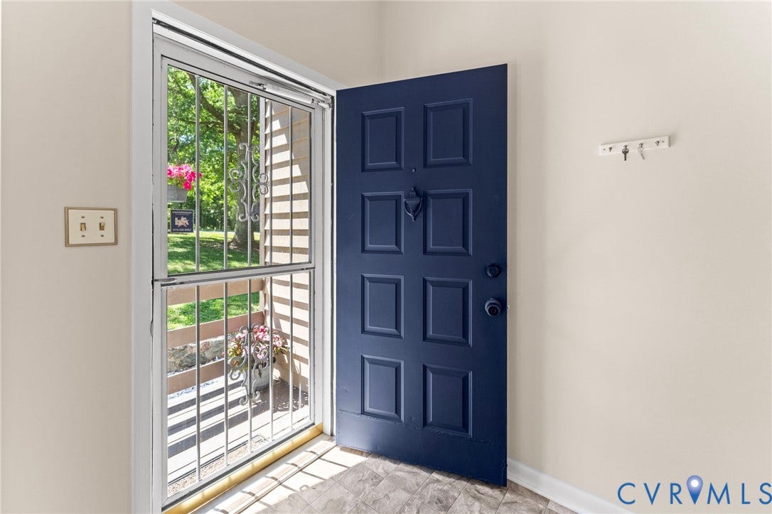 3020 Sand Hills Drive, Chester, VA 23831 Entryway featuring a paneled door with a contrasting color, a decorative door knocker, and an adjacent security screen door