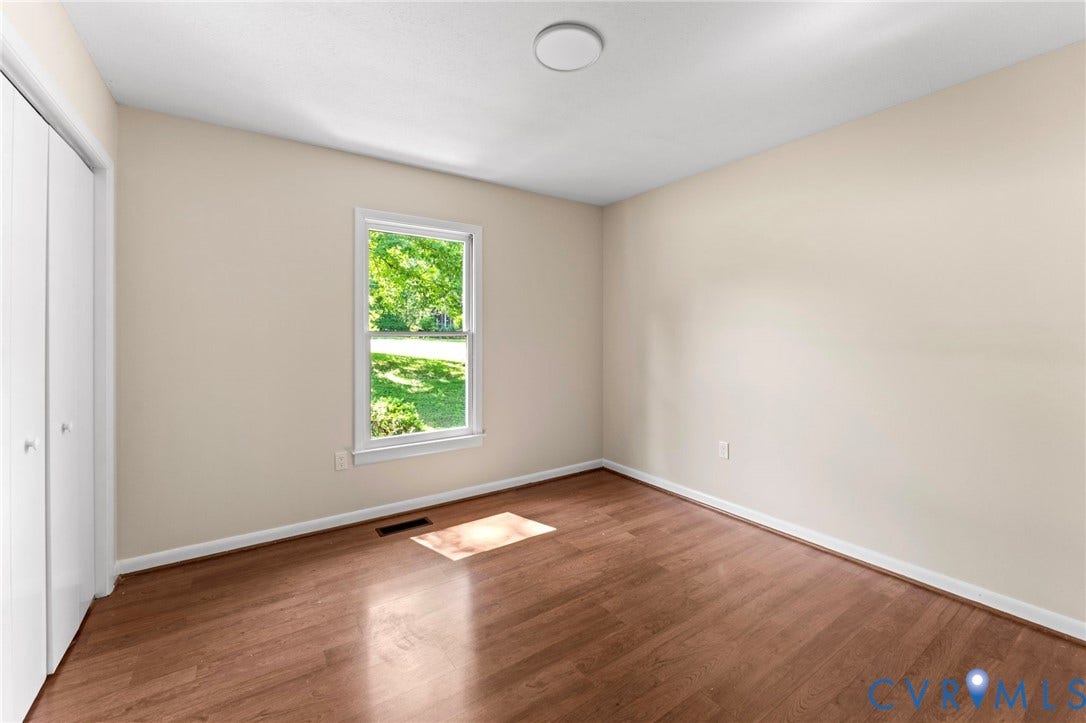 3020 Sand Hills Drive, Chester, VA 23831 Room featuring wood-finish flooring, a window with exterior views, and a dual-door closet