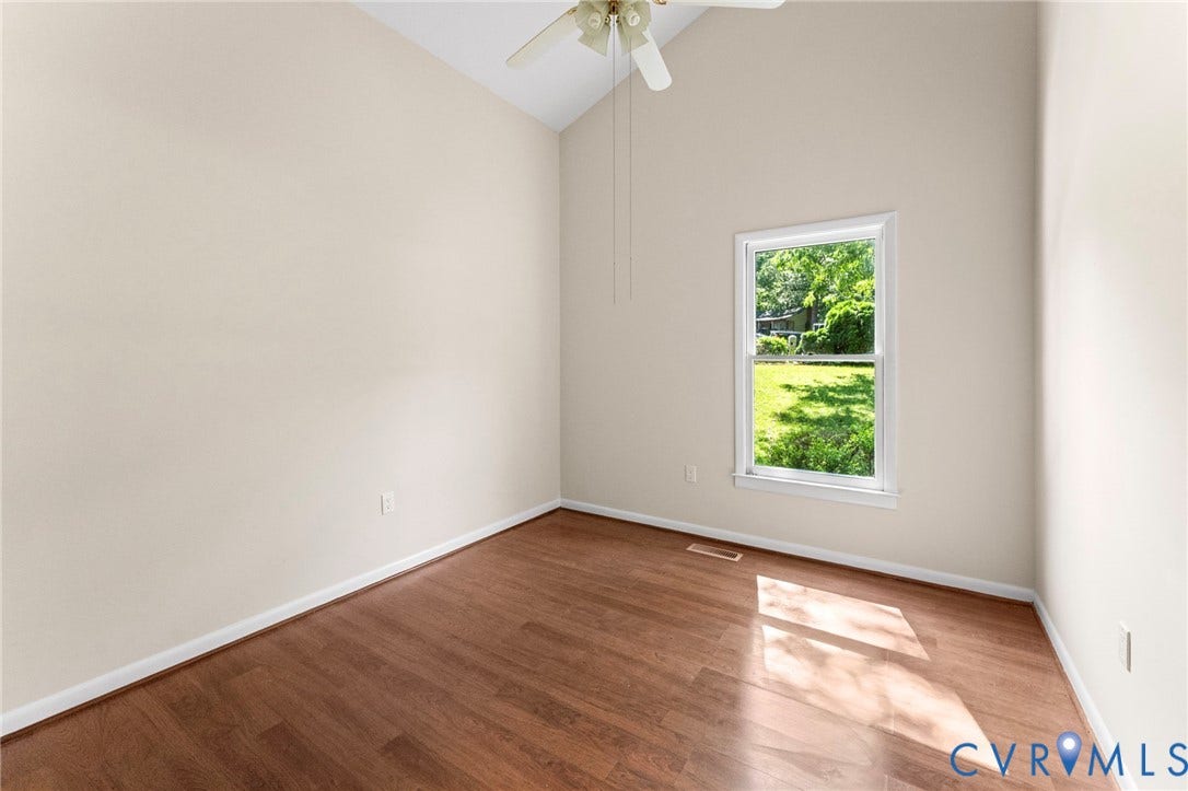 3020 Sand Hills Drive, Chester, VA 23831 Room featuring a vaulted ceiling with a ceiling fan, a window with white trim, wood-finish flooring, and light-toned wall paint