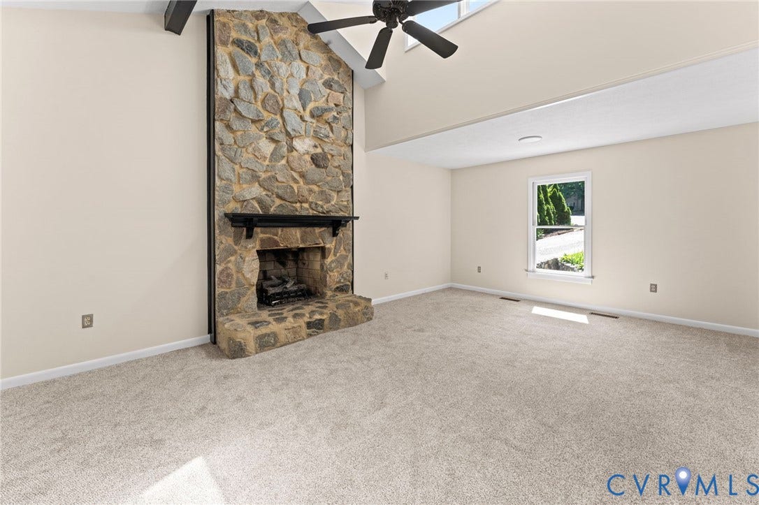 3020 Sand Hills Drive, Chester, VA 23831 Stone-clad fireplace with a dark wood mantel and hearth