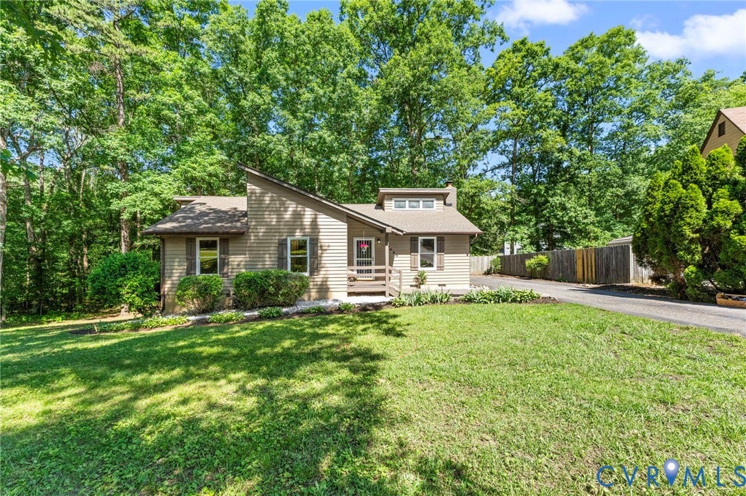 3020 Sand Hills Drive, Chester, VA 23831 Siding exterior featuring a prominent front porch, mature landscaping, a dormer window, and a paved driveway