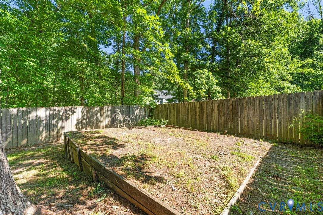 3020 Sand Hills Drive, Chester, VA 23831 Private backyard featuring a wood privacy fence and mature trees