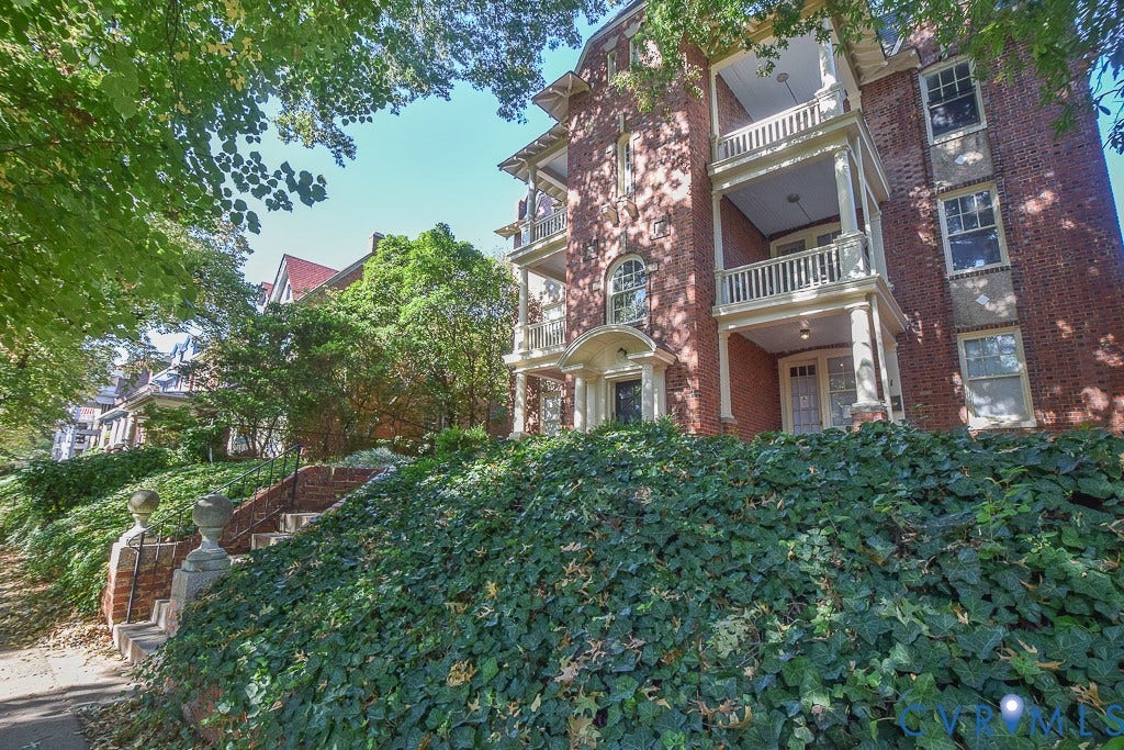 120 S Arthur Ashe Boulevard, #1, Richmond, VA 23220 Brick facade building featuring multiple balconies with white railings and columns