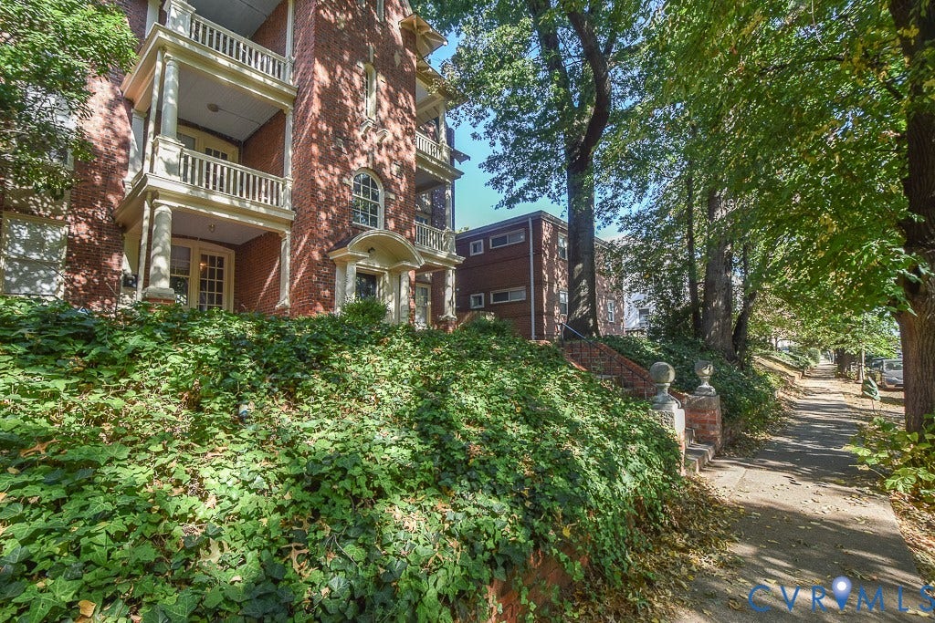120 S Arthur Ashe Boulevard, #1, Richmond, VA 23220 Brick facade building with multiple balconies, columnar supports, and an arched entry
