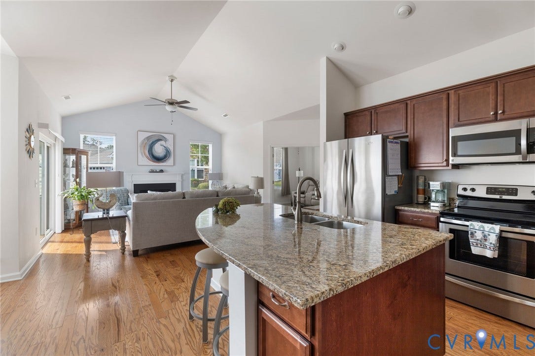 12128 Magnolia Bluff Court, Villas At Magnolia Lakes, Chester, VA 23831 Open-concept living space with a vaulted ceiling