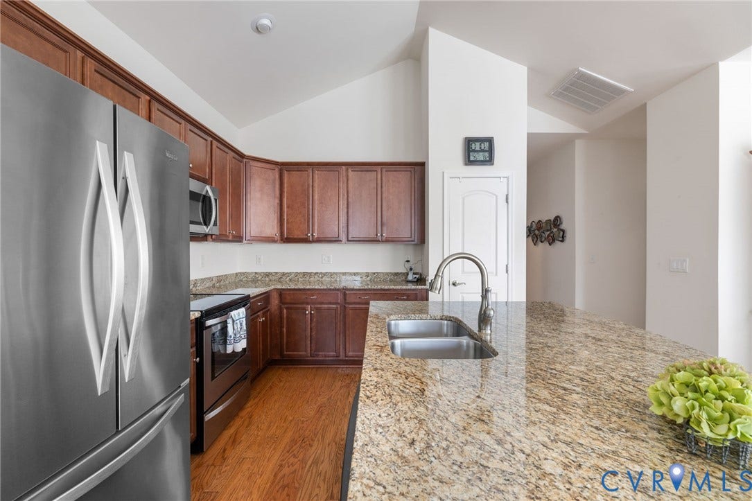 12128 Magnolia Bluff Court, Villas At Magnolia Lakes, Chester, VA 23831 Kitchen featuring an expansive granite countertop island with an undermount double-basin sink and gooseneck faucet