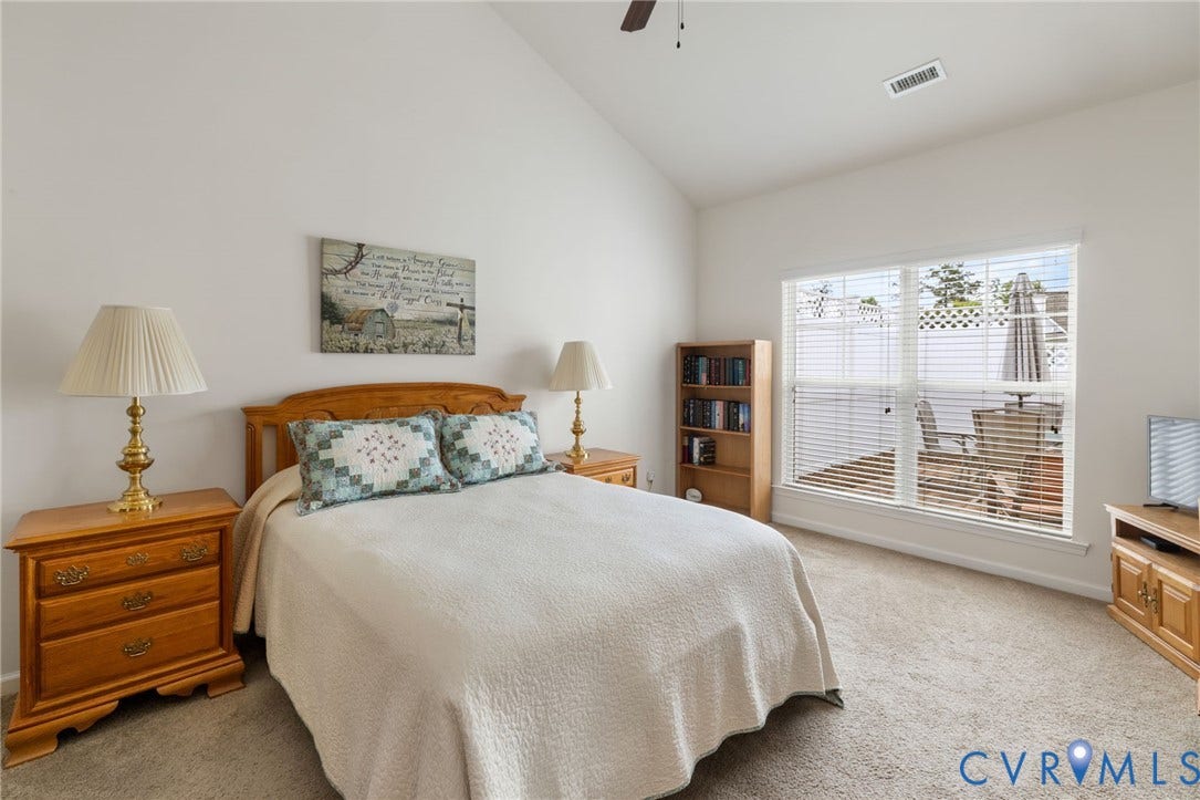 12128 Magnolia Bluff Court, Villas At Magnolia Lakes, Chester, VA 23831 Carpeted interior space featuring a vaulted ceiling and a ceiling fan