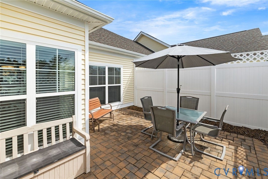 12128 Magnolia Bluff Court, Villas At Magnolia Lakes, Chester, VA 23831 Paver patio featuring a white privacy fence with lattice accents