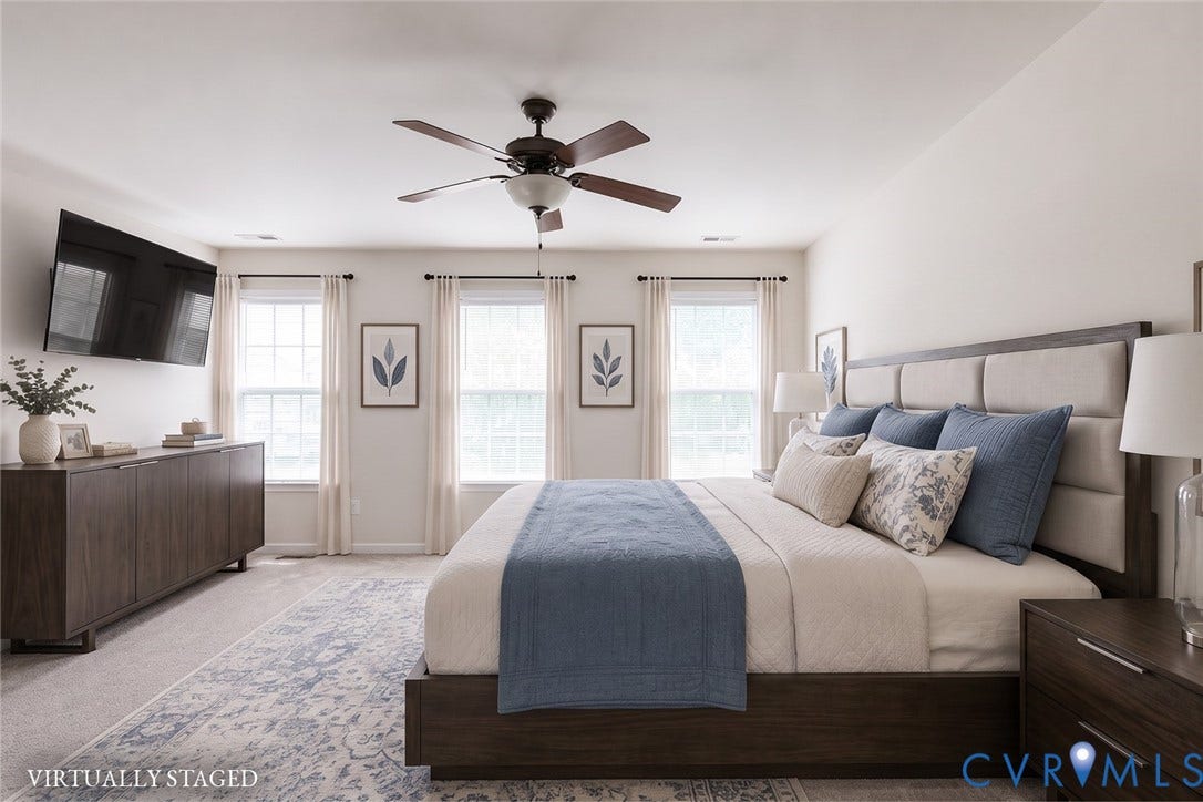 2244 Thomas Kenney Drive, Henrico, VA 23060 Spacious bedroom featuring light-toned walls, a ceiling fan with integrated lighting, and three large windows with window treatments Virtually Staged