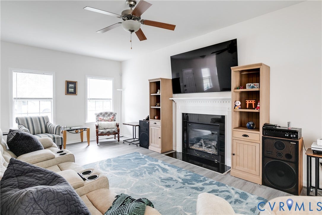 2244 Thomas Kenney Drive, Henrico, VA 23060 Family Room Featuring New LVP Flooring, Ceiling Fan, and Gas Fireplace.