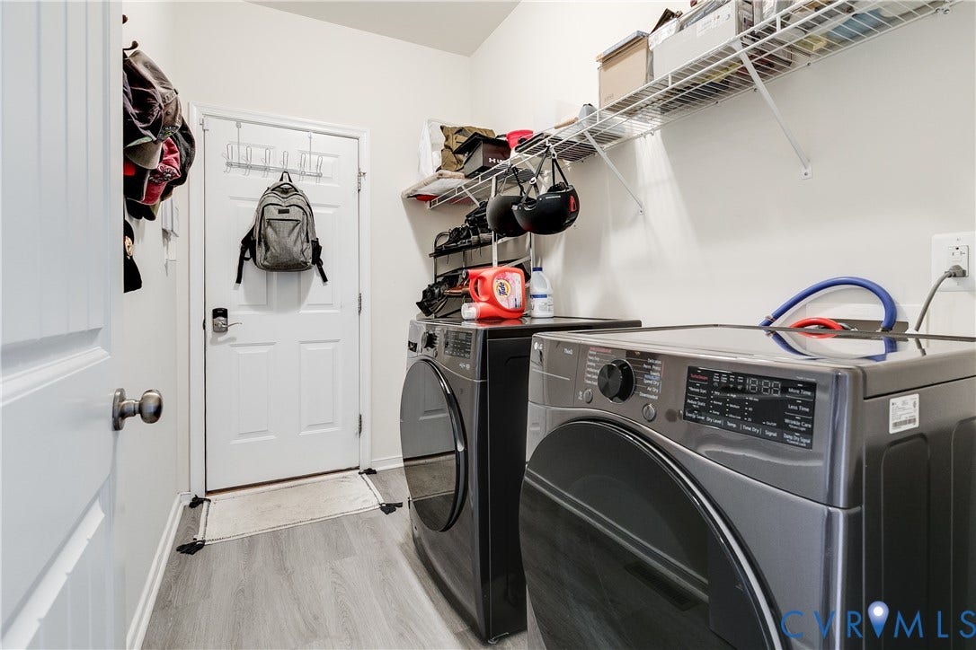 2244 Thomas Kenney Drive, Henrico, VA 23060 Laundry Room Featuring New LVP Flooring, Washer & Dryer, and Wire Shelving.