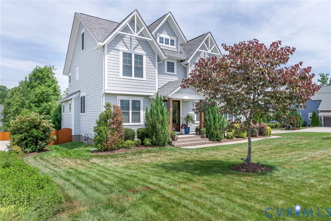 2112 Avada Drive, Newmarket Estates, Midlothian, VA 23112 Subject side view left with line of trees and bushes along side and privacy fence in rear