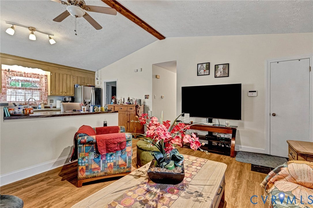 11330 Great Branch Drive, Chester, VA 23831 Expansive living area featuring vaulted ceilings, wood-finish flooring, and an open concept layout