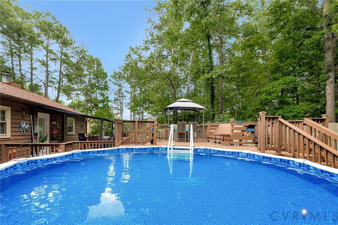 11330 Great Branch Drive, Chester, VA 23831 Expansive outdoor space featuring an above-ground pool, multi-level wood deck, and a gazebo