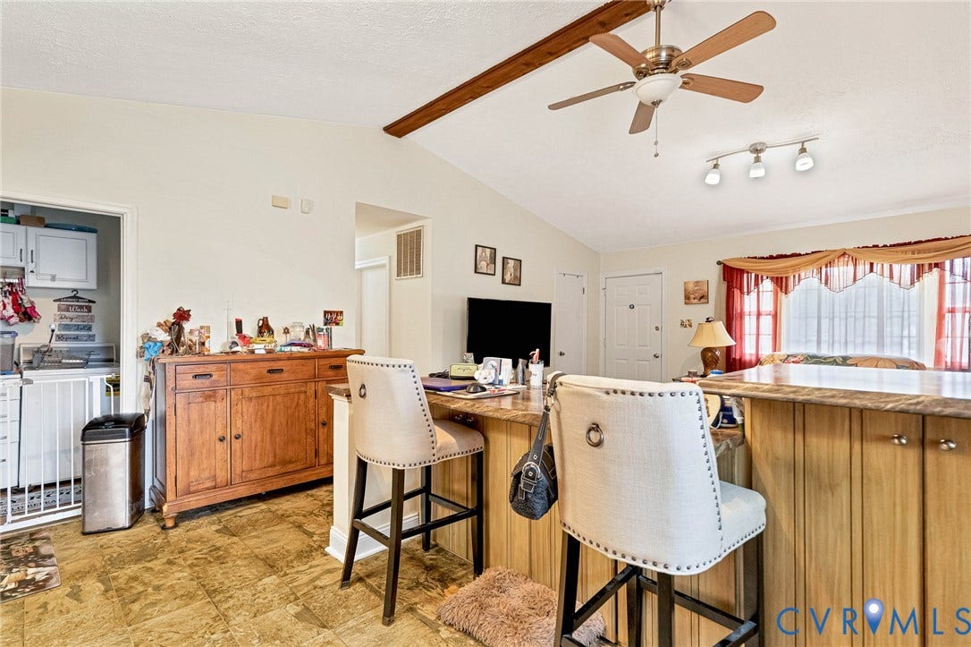 11330 Great Branch Drive, Chester, VA 23831 Kitchen island featuring a wood-finish base and a light-toned countertop