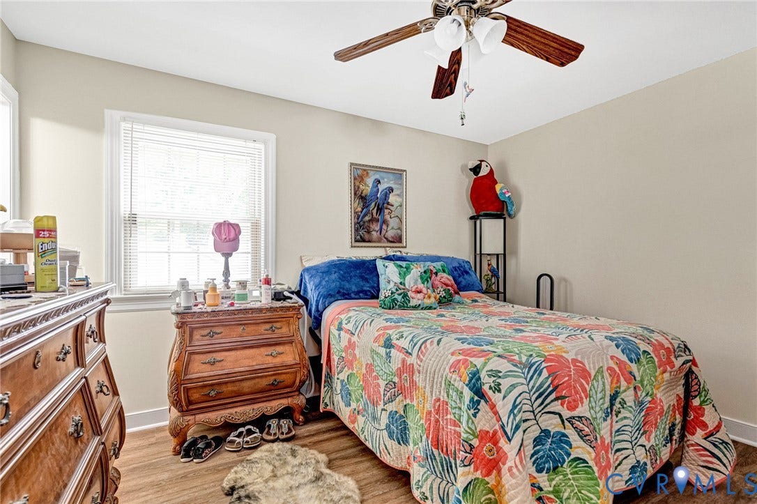 11330 Great Branch Drive, Chester, VA 23831 Room featuring a window with blinds, light-toned walls, wood-finish flooring, and a ceiling fan with integrated lighting