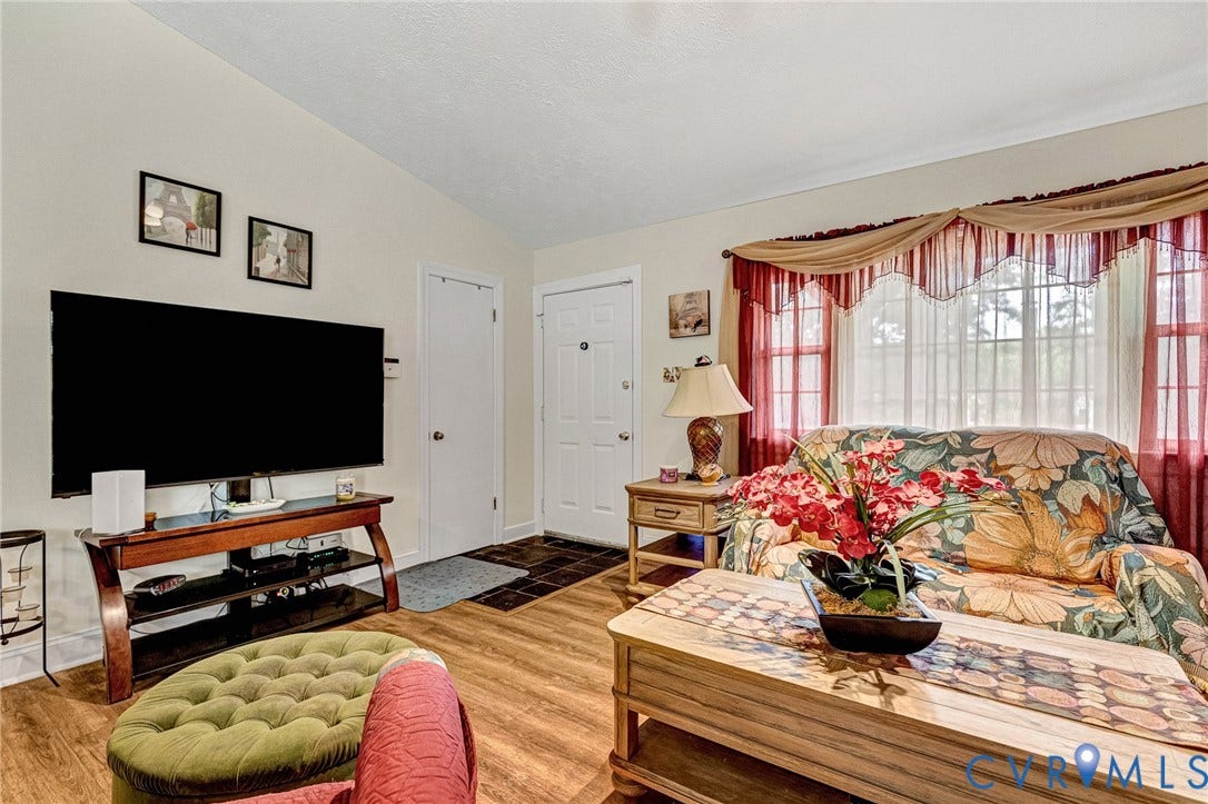 11330 Great Branch Drive, Chester, VA 23831 Living area featuring wood-finish flooring, vaulted ceilings, and a large window