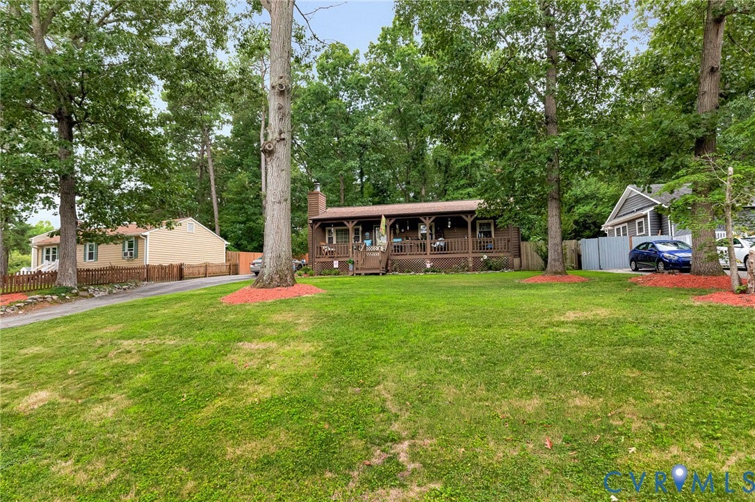11330 Great Branch Drive, Chester, VA 23831 Wood-sided home with an expansive front yard featuring mature trees