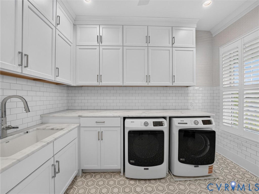 Laundry room featuring white shaker-style cabinetry, a white subway tile backsplash, and a large sink with a gooseneck faucet