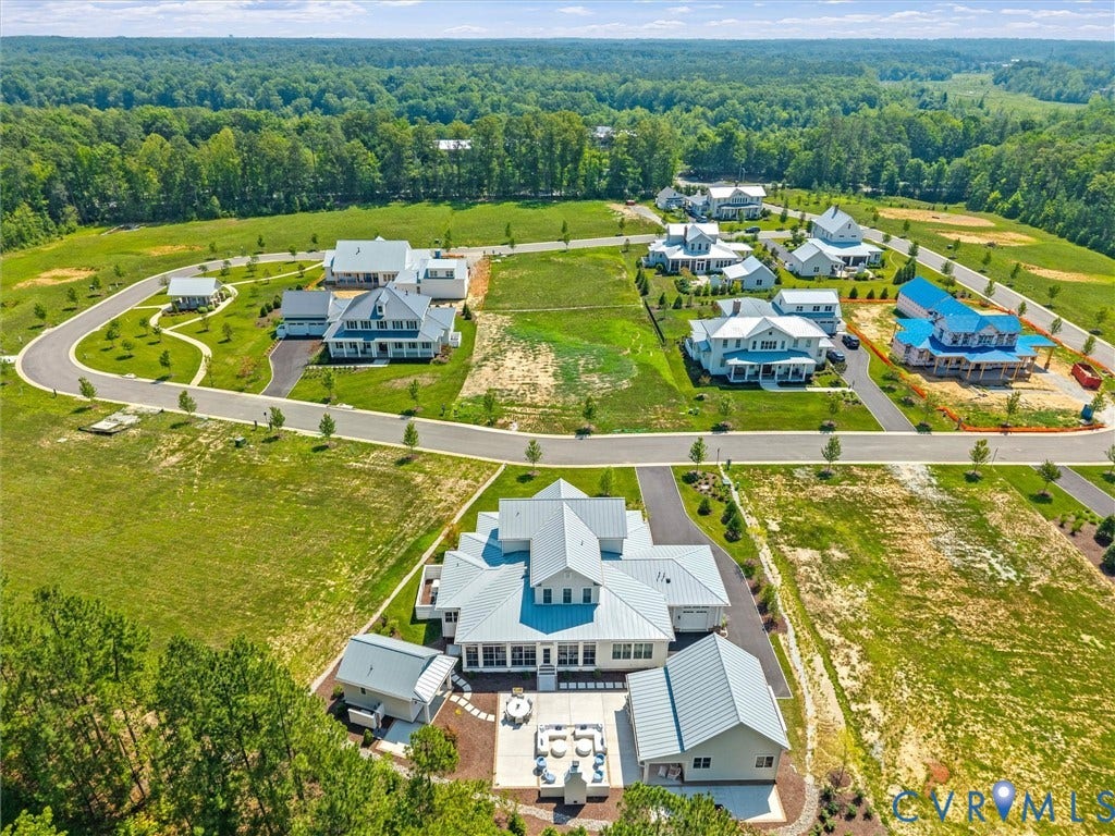 Newly developed community featuring multiple residences with light-colored siding and metal roofs
