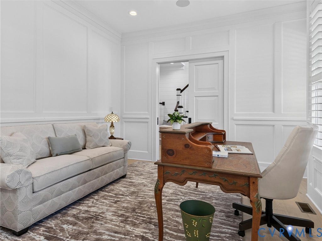 Room featuring wainscoting and crown molding details