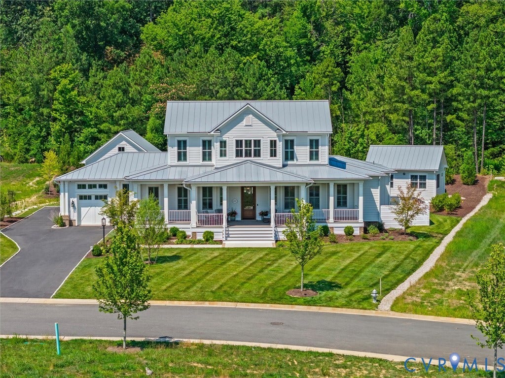 White siding exterior featuring a covered porch with white columns and railing
