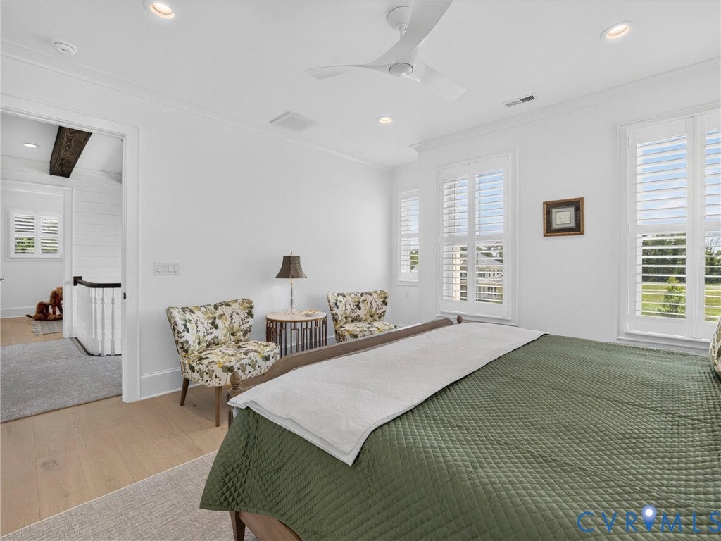 Bright interior space featuring light wood-finish flooring and white walls
