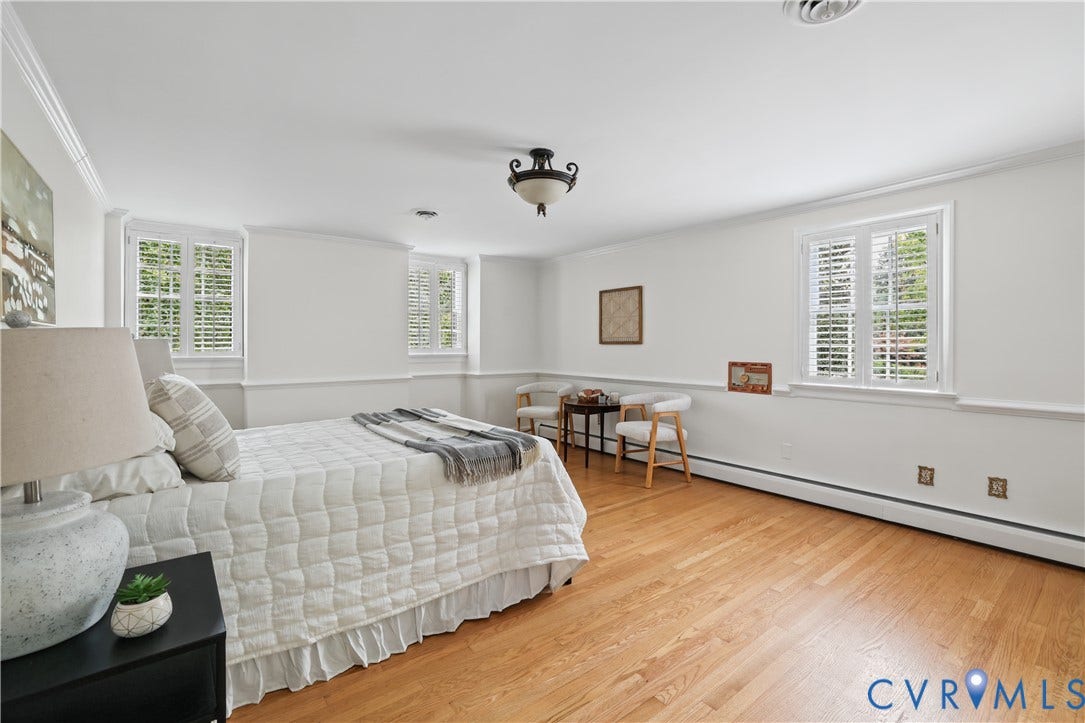 5418 Cary Street Road, Richmond, VA 23226 Spacious interior featuring wood-finish flooring, crisp white wall molding, plantation shutters, and a decorative ceiling-mounted light fixture