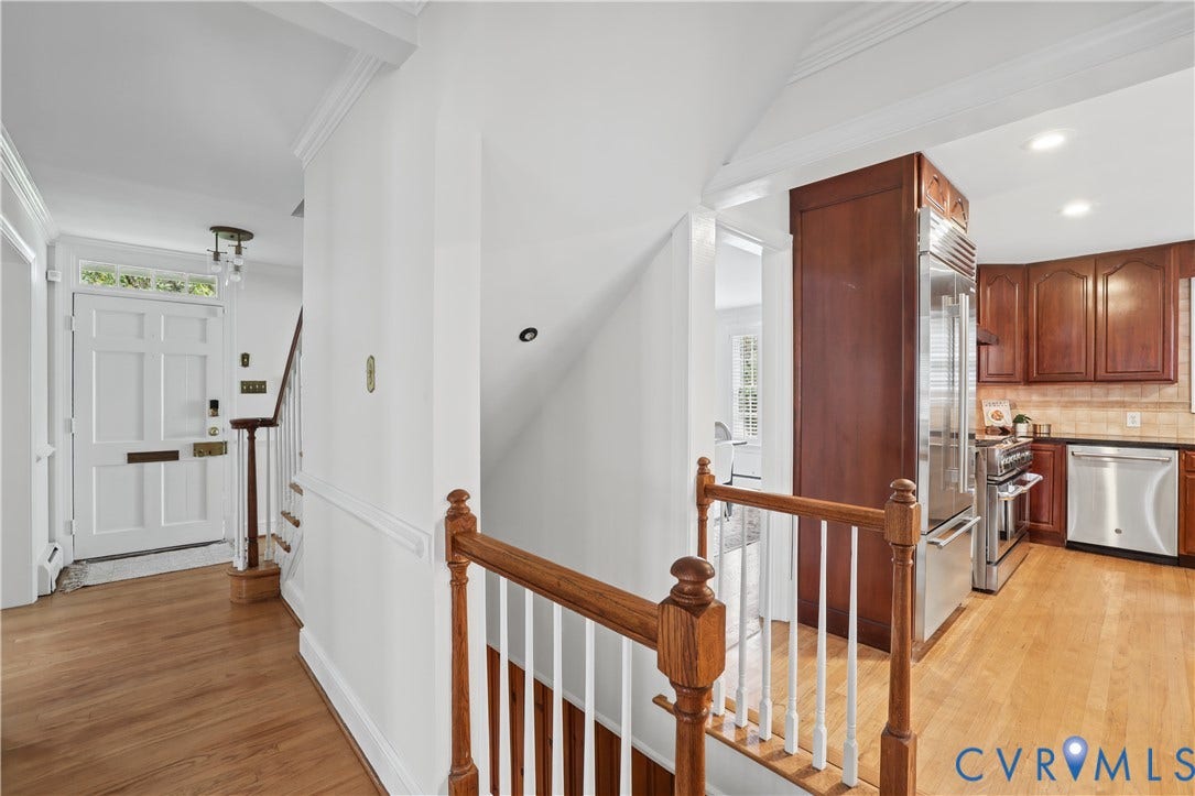 5418 Cary Street Road, Richmond, VA 23226 Entryway featuring a multi-panel door with transom window, wood-finish flooring, and a decorative wood banister