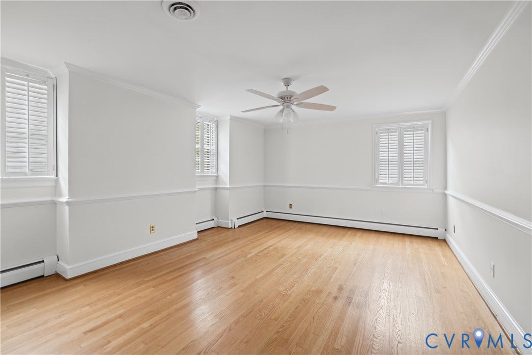 5418 Cary Street Road, Richmond, VA 23226 Interior space featuring wood-finish flooring, chair rail molding, shutter-style window treatments, and a ceiling fan with integrated light fixture