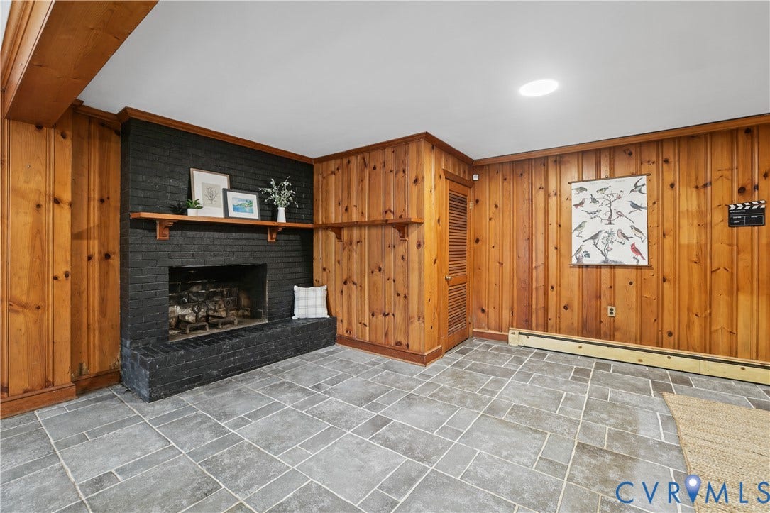 5418 Cary Street Road, Richmond, VA 23226 Rec Room featuring knotty wood-panelled walls, a painted brick fireplace with a wood mantel, stone flooring, and a louvered door closet