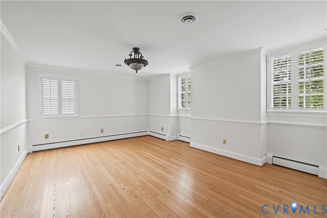 5418 Cary Street Road, Richmond, VA 23226 Interior space featuring wood-finish flooring, chair rail molding, shutter-style window coverings, and a central multi-arm ceiling light fixture