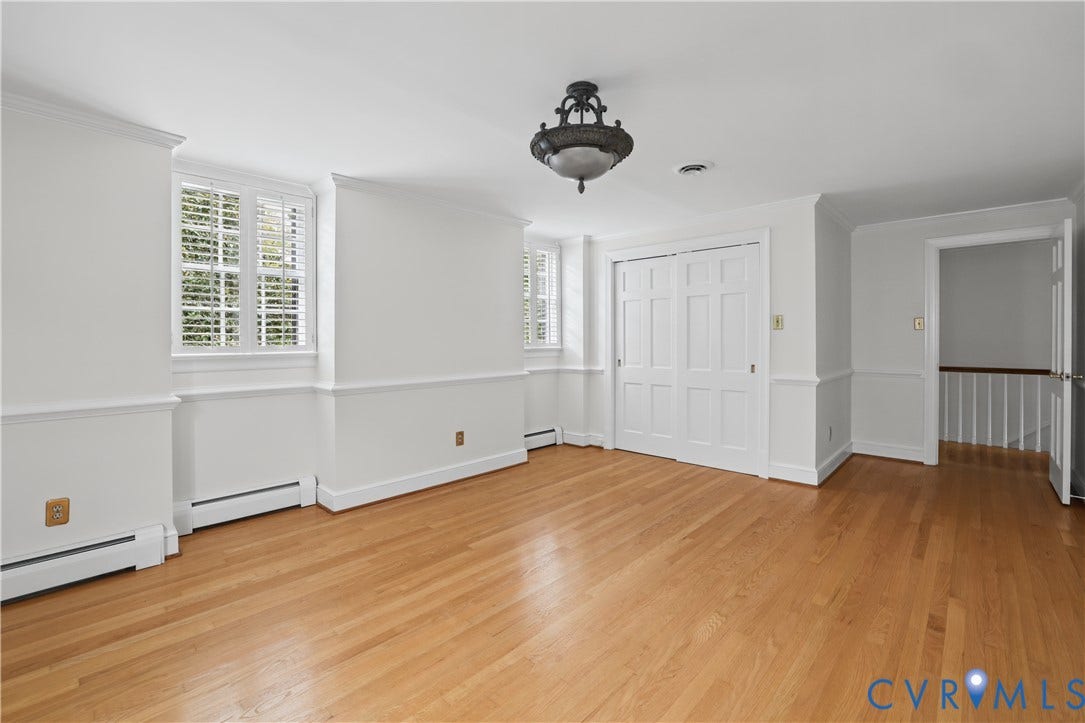 5418 Cary Street Road, Richmond, VA 23226 Wood-finish flooring, multi-panel doors, chair rail molding, shutter-style window treatments, and a decorative ceiling light fixture
