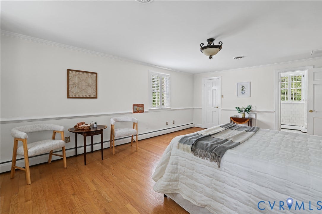 5418 Cary Street Road, Richmond, VA 23226 Spacious interior featuring wood-finish flooring, chair rail molding, multi-pane window with interior shutters, and a classic semi-flush mount light fixture