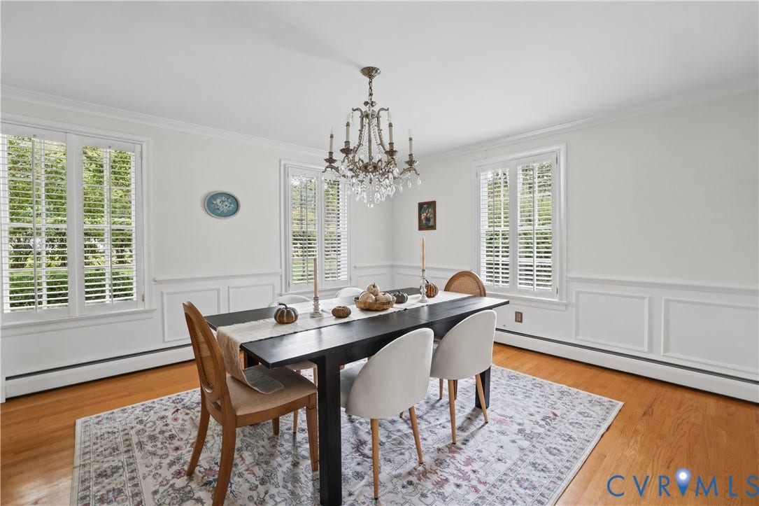 5418 Cary Street Road, Richmond, VA 23226 Hardwood flooring, wainscoting, white plantation shutters, and a crystal chandelier
