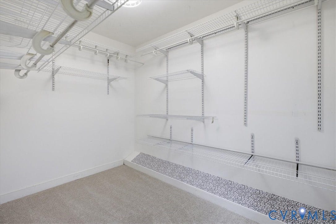 The walk-in closet to the primary bedroom an adjustable organizing system to maximize space.
