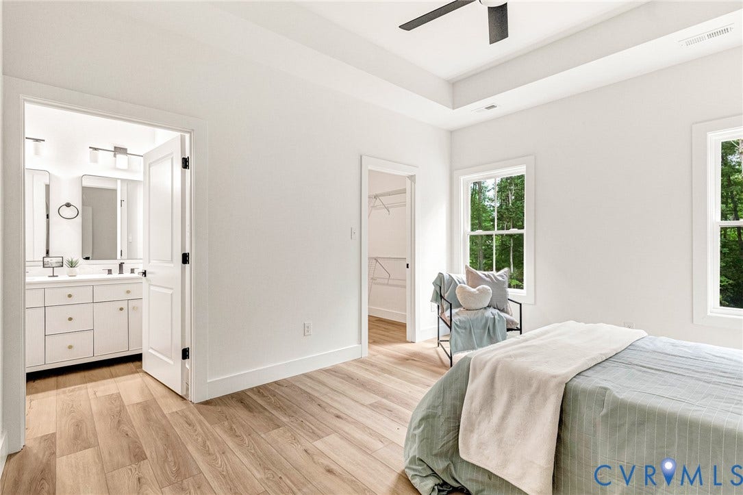 716 Pine Harbour Drive, Pine Harbour, Mineral, VA 23117 Bedroom with light wood-finish flooring, recessed tray ceiling, and a ceiling fan