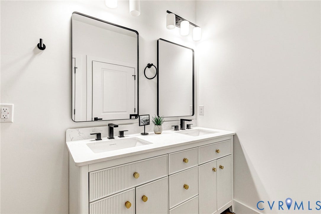 716 Pine Harbour Drive, Pine Harbour, Mineral, VA 23117 Double vanity with white cabinetry, gold-tone hardware, and integrated sinks