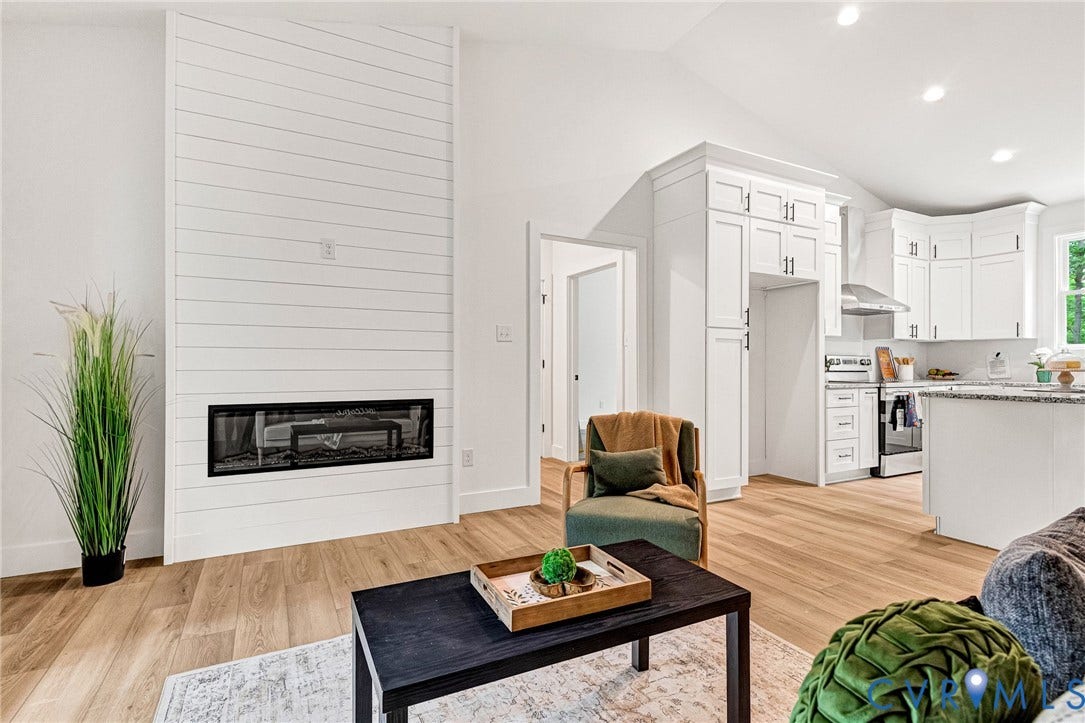 716 Pine Harbour Drive, Pine Harbour, Mineral, VA 23117 Living area featuring a floor-to-ceiling shiplap fireplace with a linear electric insert