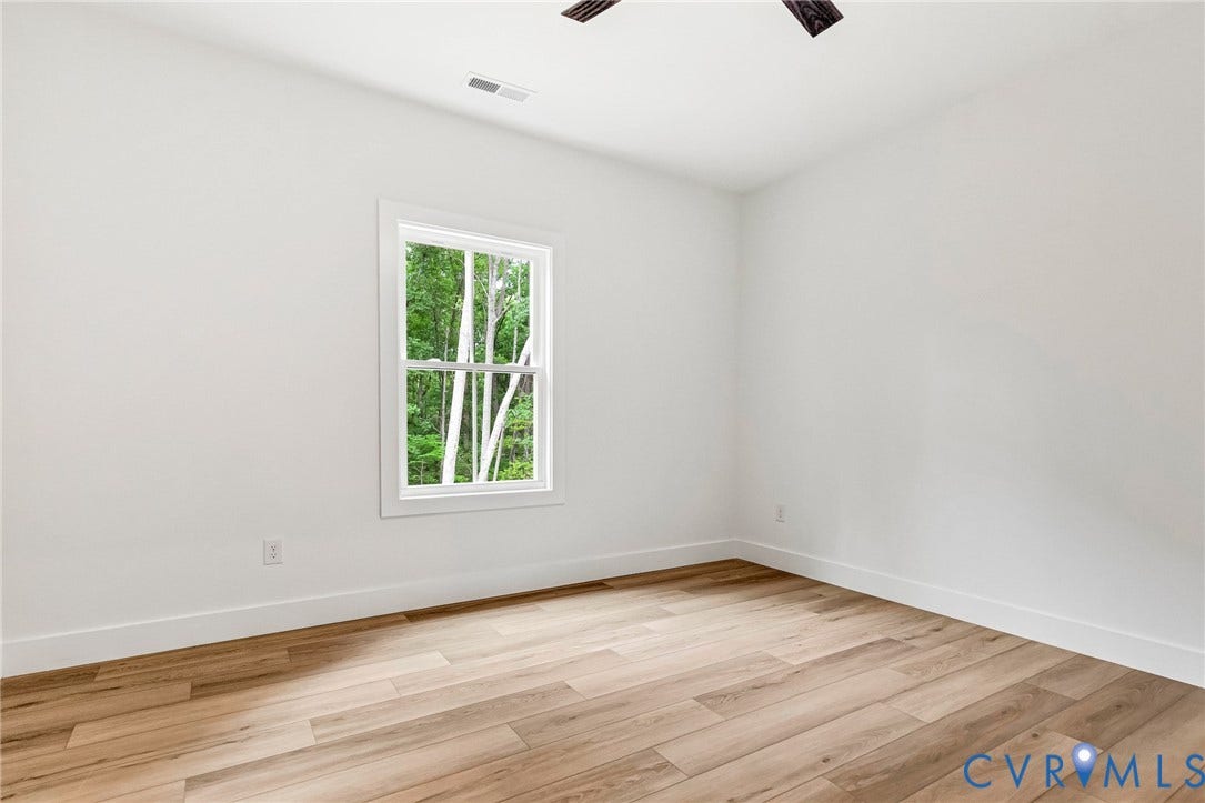 716 Pine Harbour Drive, Pine Harbour, Mineral, VA 23117 Room featuring wood-finish flooring, white baseboards, and a double-hung window with white trim