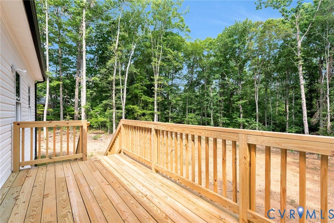 716 Pine Harbour Drive, Pine Harbour, Mineral, VA 23117 Expansive outdoor deck crafted from natural wood, featuring a sturdy wood railing and integrated steps