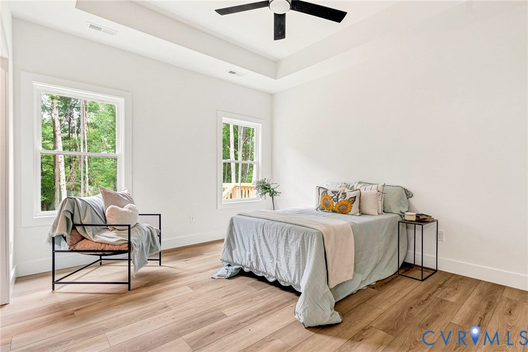 716 Pine Harbour Drive, Pine Harbour, Mineral, VA 23117 Bright interior space featuring wood-finish flooring, white walls, and a tray ceiling with a ceiling fan
