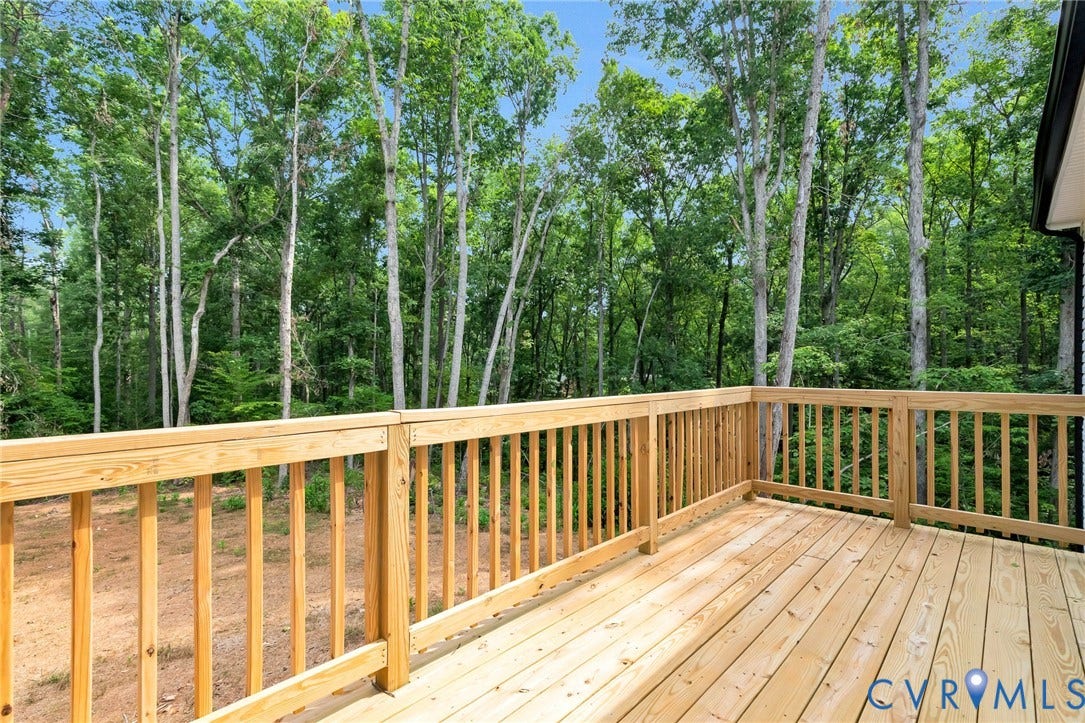 716 Pine Harbour Drive, Pine Harbour, Mineral, VA 23117 Expansive wooden deck with natural wood railing overlooking a wooded landscape