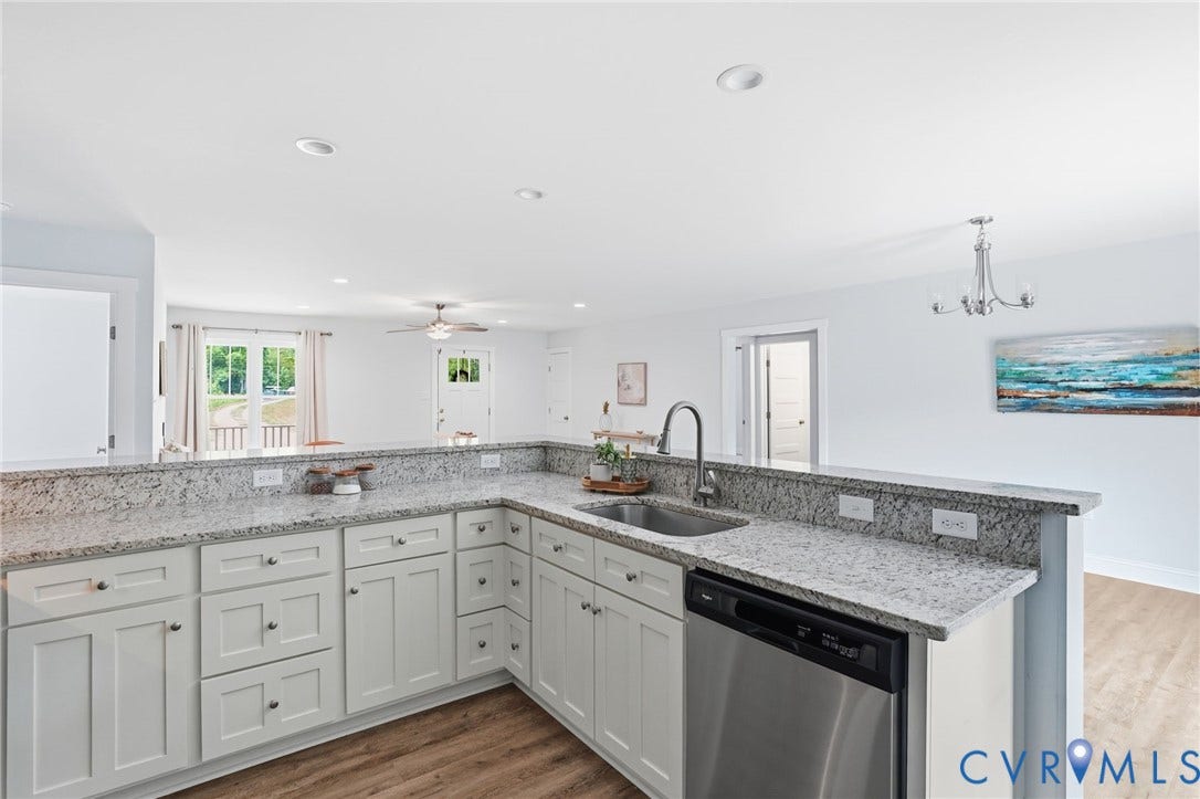 2677 Dogtown Road, Goochland, VA 23063 Kitchen featuring extensive countertop space, white cabinetry with dark hardware, stainless steel sink with a gooseneck faucet, and a stainless steel dishwasher