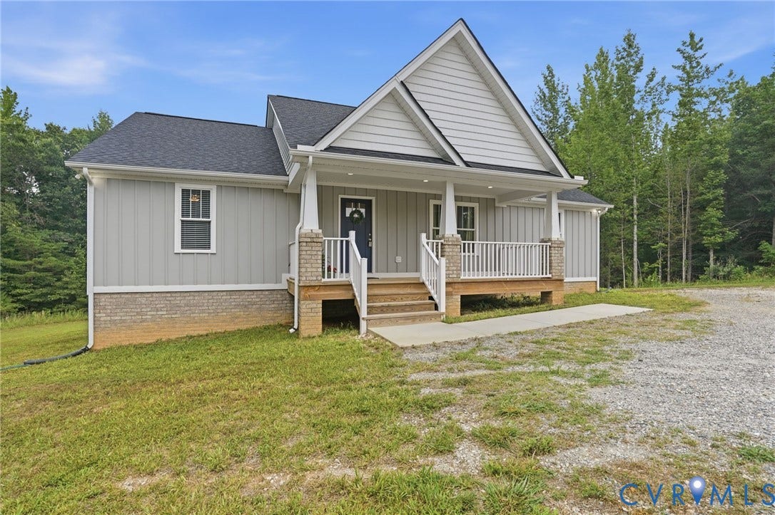2677 Dogtown Road, Goochland, VA 23063 Contemporary ranch-style exterior featuring light gray vertical siding, a dark gray shingle roof, and a welcoming covered porch with white railings