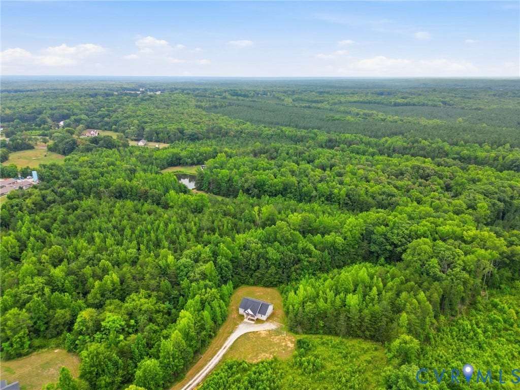 2677 Dogtown Road, Goochland, VA 23063 Extensive wooded acreage with a single-family residence featuring a dark roof and light siding