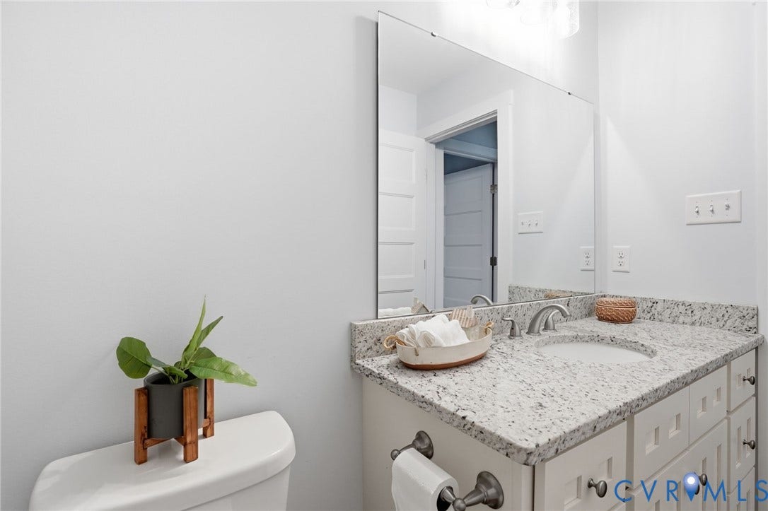 2677 Dogtown Road, Goochland, VA 23063 Bathroom vanity featuring a speckled countertop, undermount sink, and brushed nickel faucet