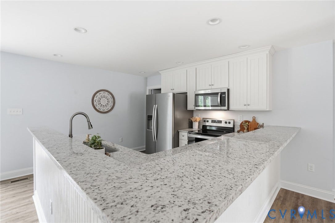 2677 Dogtown Road, Goochland, VA 23063 Kitchen featuring light-toned countertops, white cabinetry, a built-in sink with a gooseneck faucet, stainless steel appliances, and recessed lighting