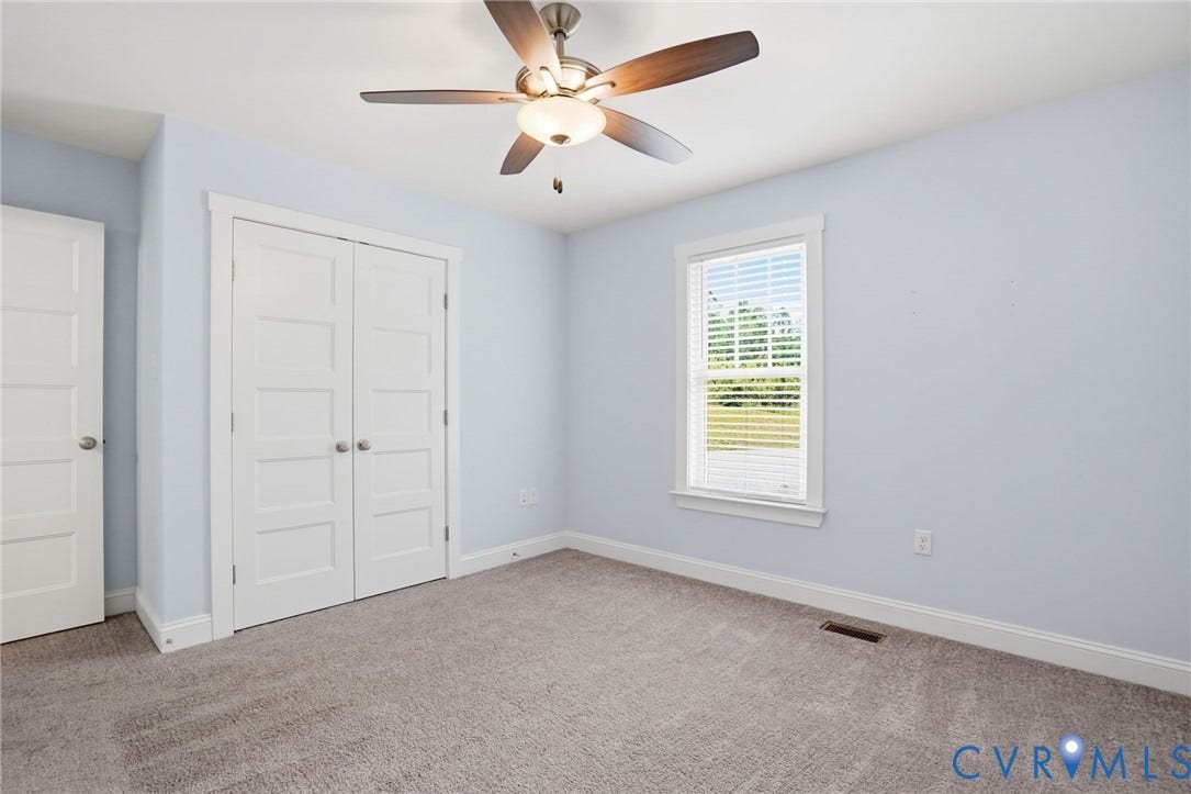 2677 Dogtown Road, Goochland, VA 23063 Bedroom featuring neutral carpet flooring, a ceiling fan with integrated lighting, and a window with blinds